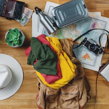 flat lay of travel items in backpack