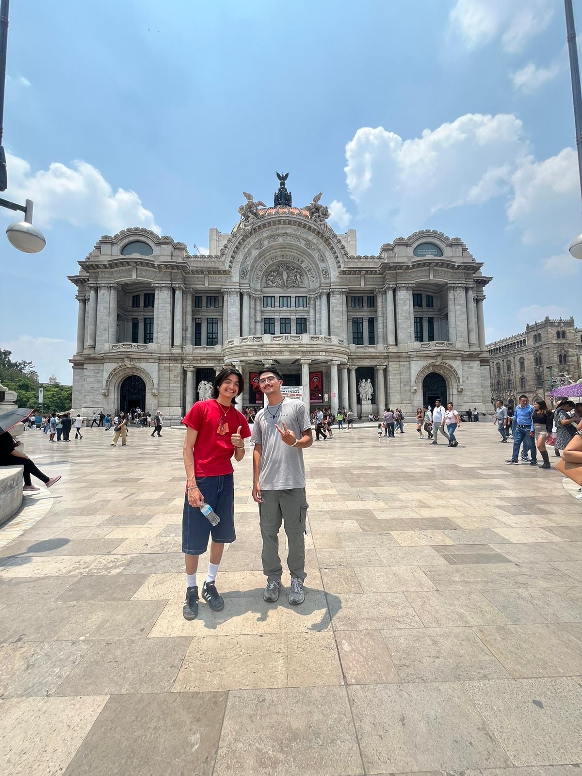 Jonathan Beas and Cristopher Miranda posing in front of the Palacio de Bellas Artes in Mexico City