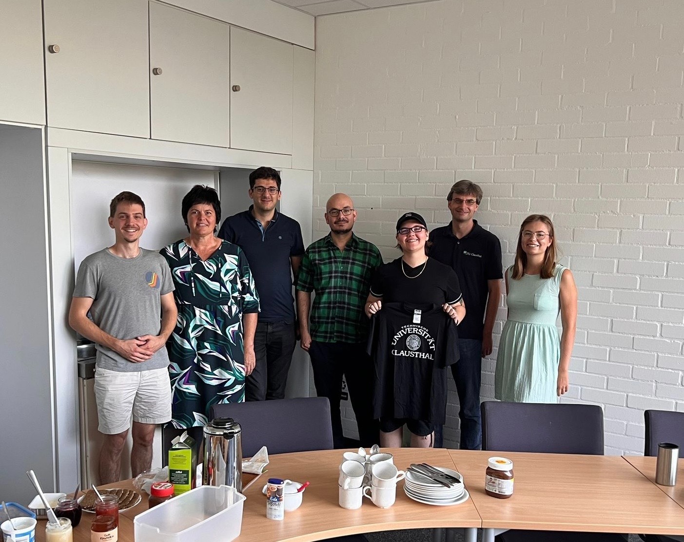 Tamara Hinderman in group photo with six coworkers in Germany