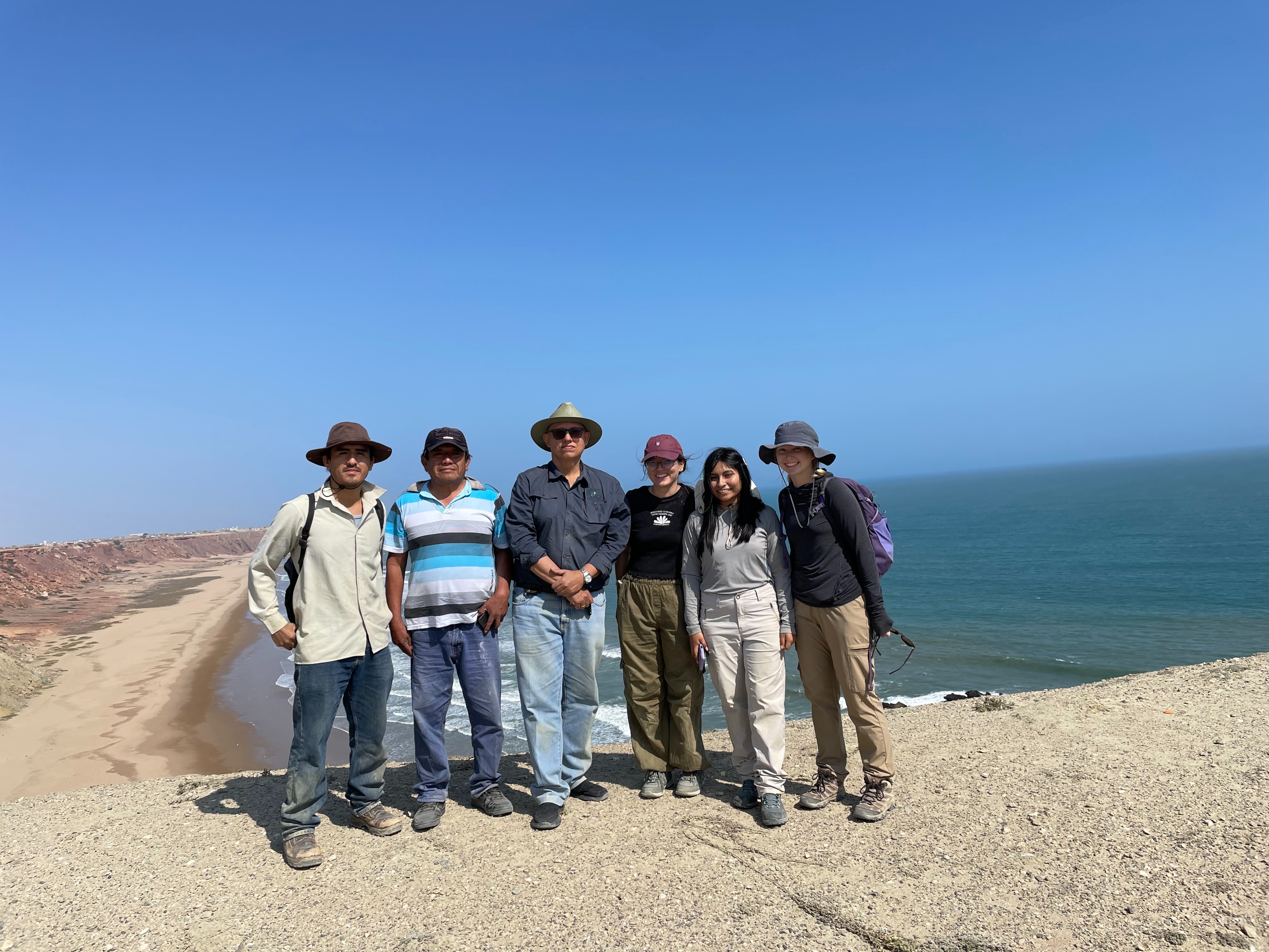 Markey Freudenburg-Puricelli in a red cap standing with five co-workers in Chile