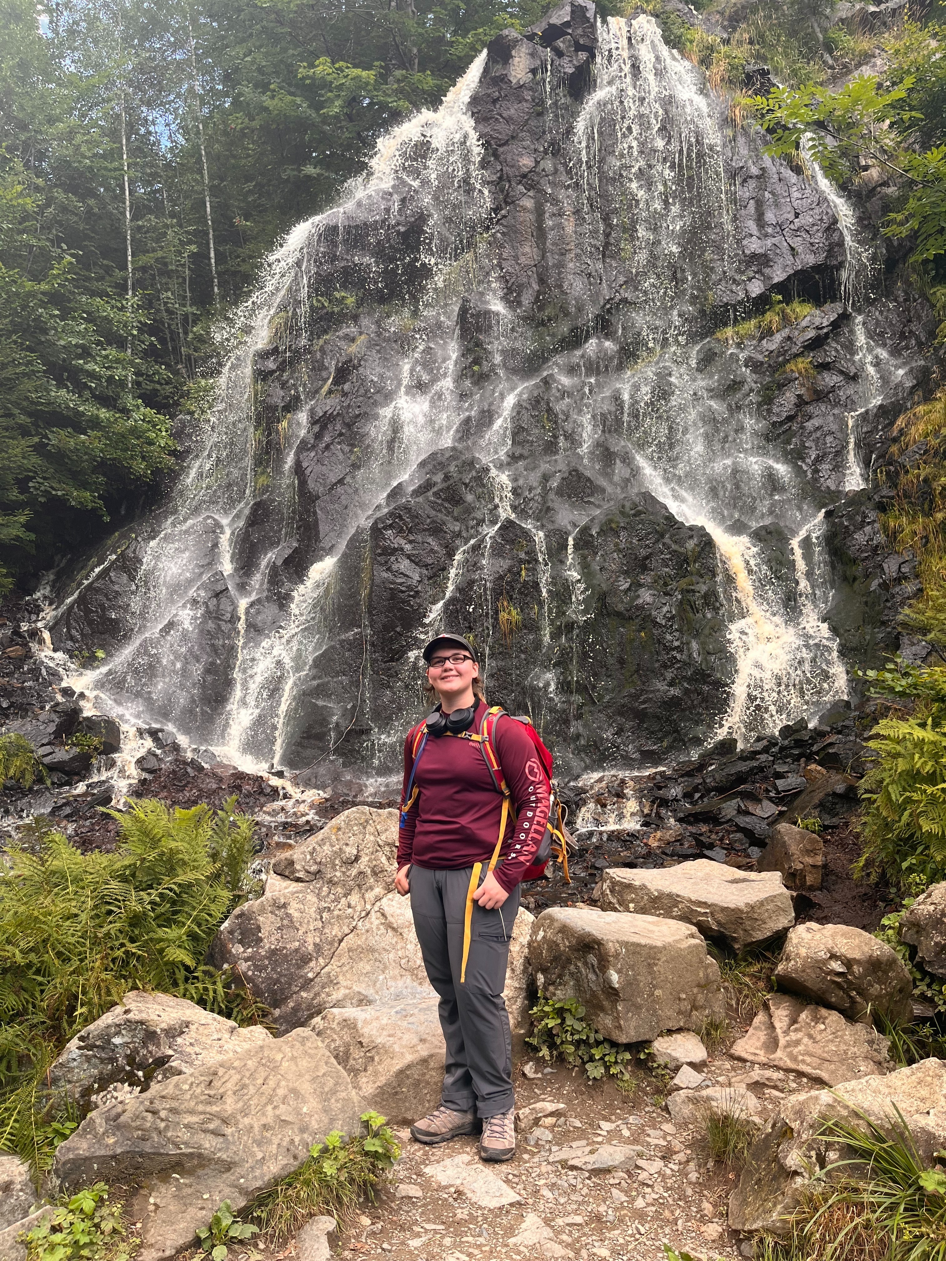 Tamara Hinderman in front of waterfall while on a hike in Germany