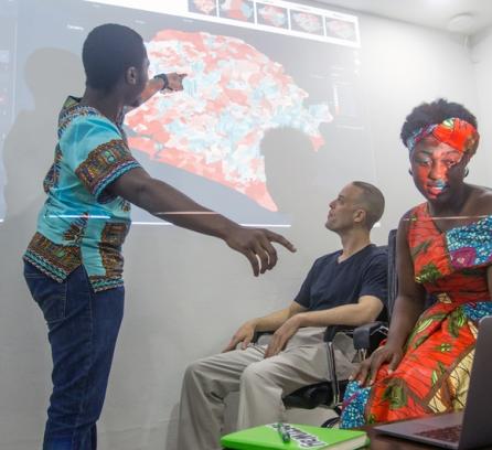 students pointing at projector image