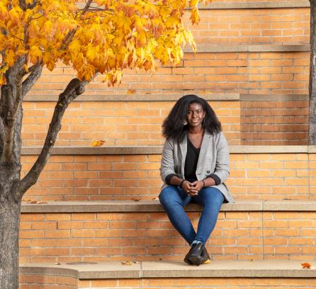 Andrea Orji, an MIT senior and chemical engineering major, sitting in the amphitheater near the Stata Center