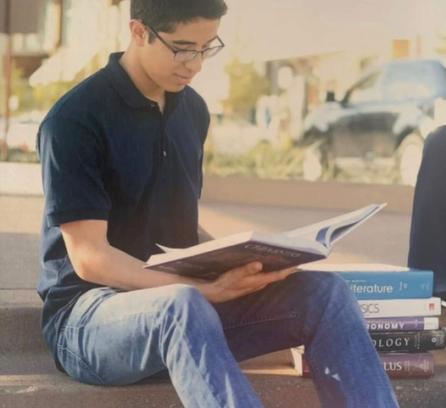 Sergio Dominguez reading textbooks outside