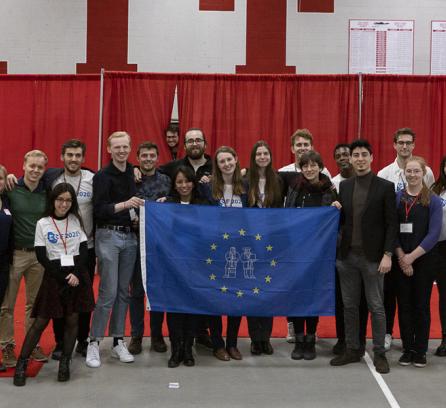 European Career Fair board members posing for a picture with a blue banner