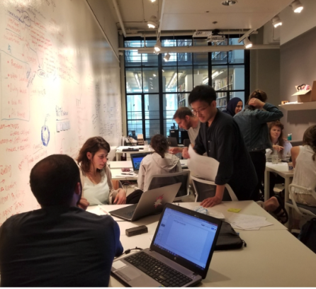 MIT students working on a collaboration in open workspace