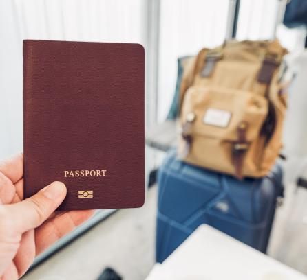 Hand holding passport in airport