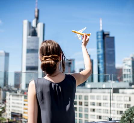 Woman holding toy airplane in frankfurt
