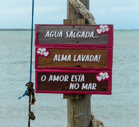 Signpost in portuguese language in the beach