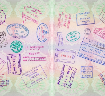 open passport showing numerous visa stamps