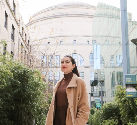 Profile shot of Audrey Lorvo surrounded by greenery with the MIT dome in the background