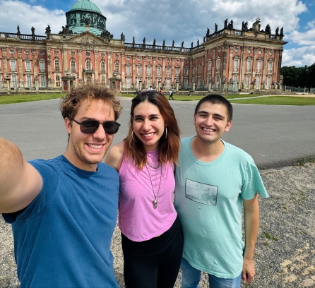 A selfie with Alexandra Valdepenas Ramirez in the middle of two other MIT students in front of New Palace in Germany