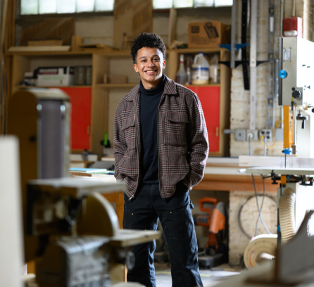 C Jacob Payne poses in an architecture lab space