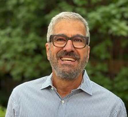 Headshot of Zairo Borges Cheibub behind some trees