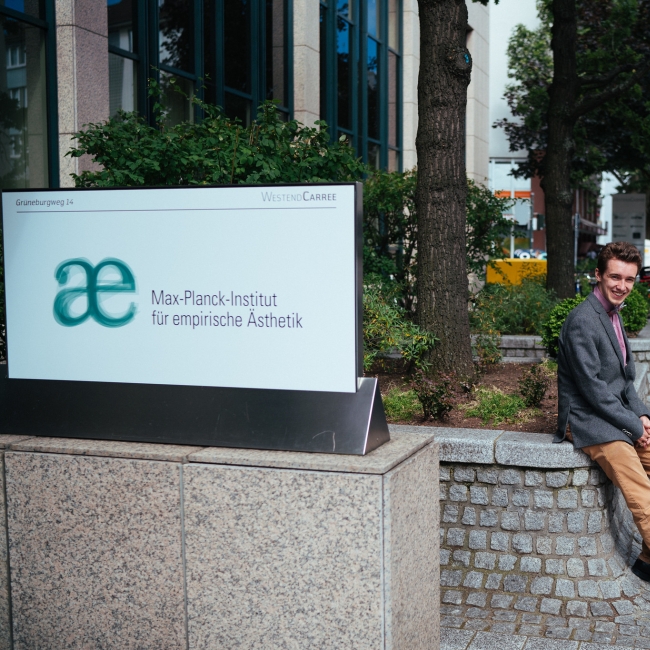 Student next to host sign in Germany