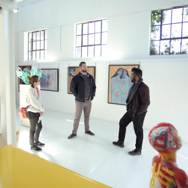 Students and program manager in gallery