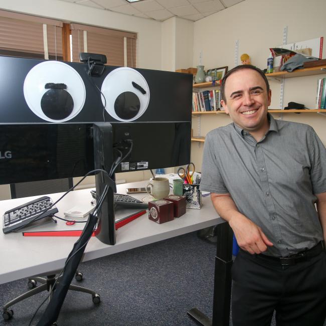 Matt Burt posing next to computer