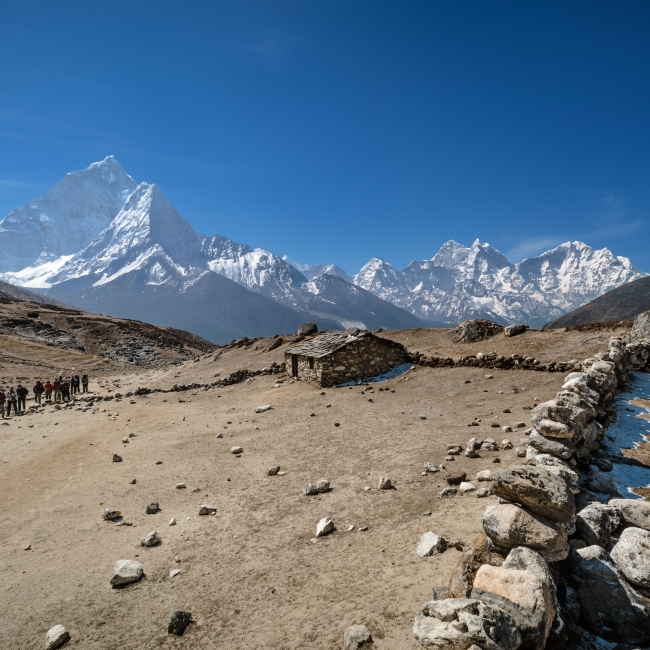 Scenic picture of Nepal mountains covered snow and a gravel path