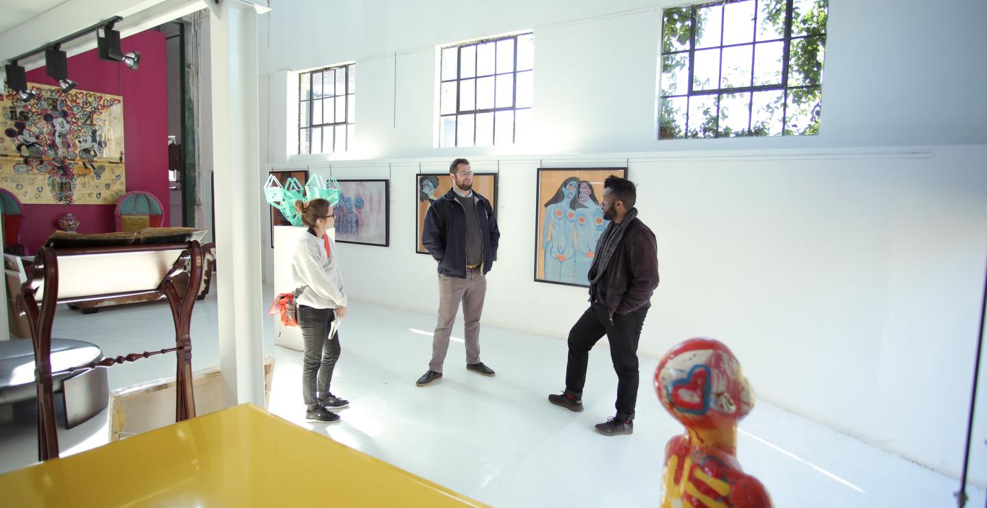 Students and program manager in gallery
