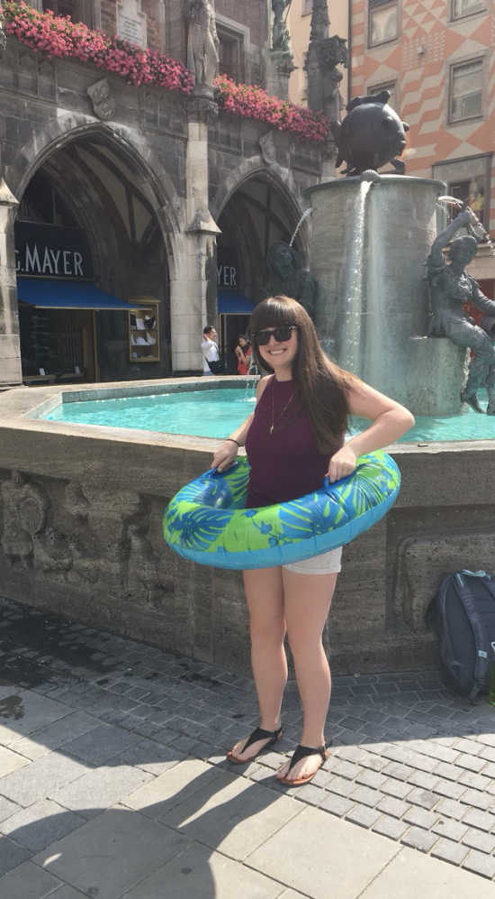 Student intern Kaleigh Hunt at fountain with inner tube