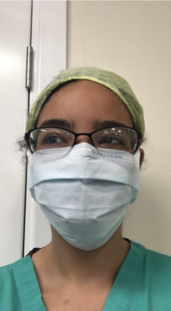 Head shot of student wearing medical scrubs and face mask