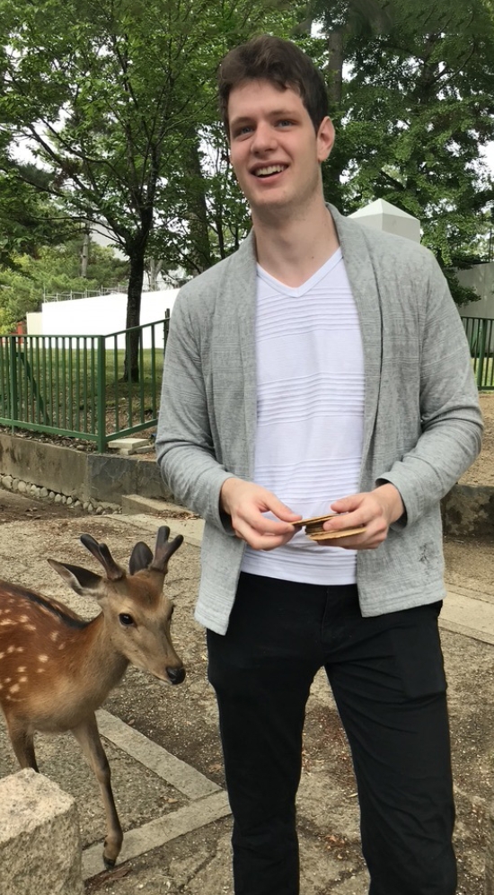Student with deer in Japan