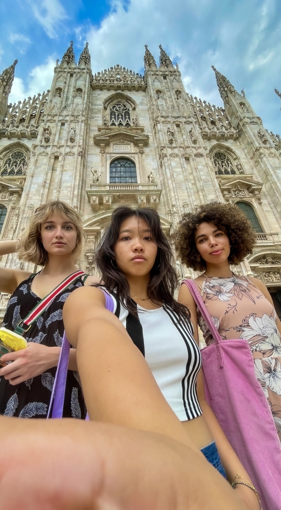 Emma Suh in a high-angle selfie with two other MIT students in front of the Duomo di Milano