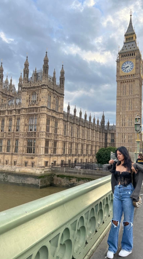 Opalina Vetrichelvan posing on the Tower Bridge on River Thames with Big Ben in the background