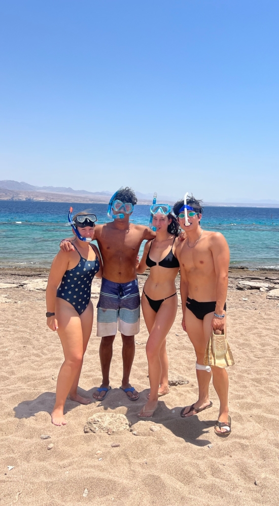 Yajvan Ravan and three other MIT MISTI student in a snorkel masks on Coral Beach in Israel