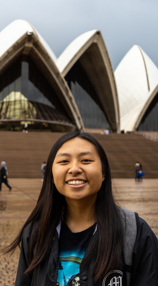 Audrey Chen headshot with the Sydney Opera House in the background on a cloudy day