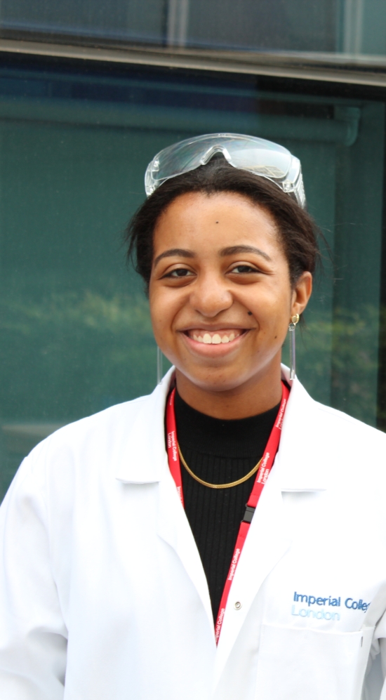 Student with white lab coat and safety goggles