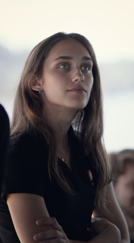 Side profile of Ashley Margetts in a black collared tee uniform looking away
