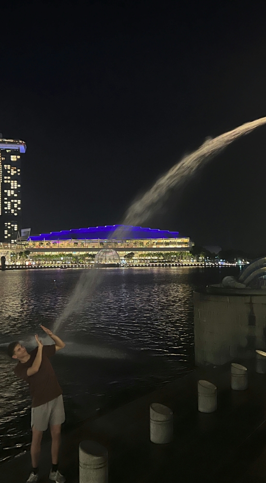 Jackson Biley with lion statue in Singapore