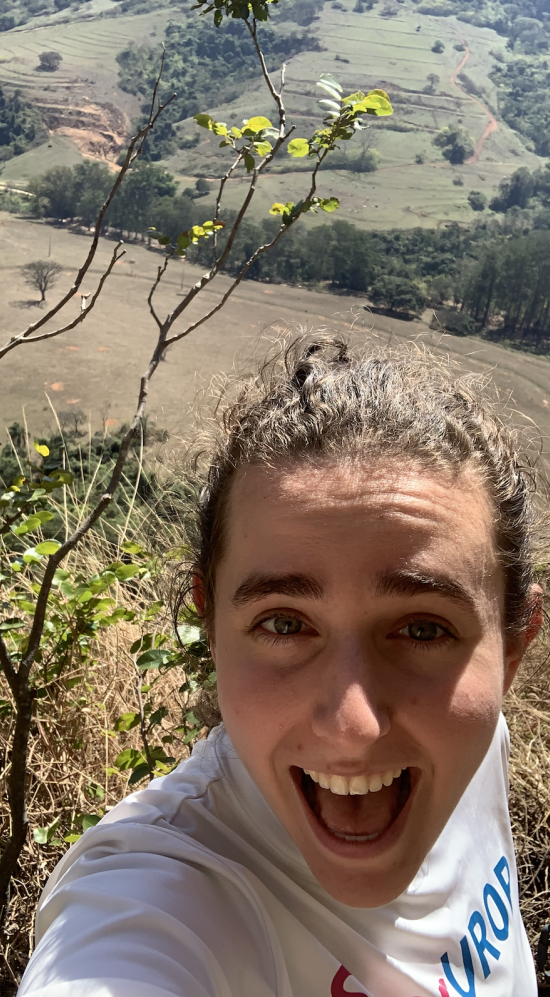 A selfie of Nina Gerszberg with a green field to the bottom