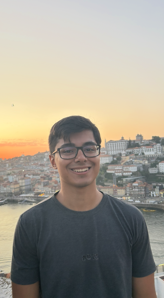 Mid shot of Paulo Henrique during a sunset overlooking a coastal city