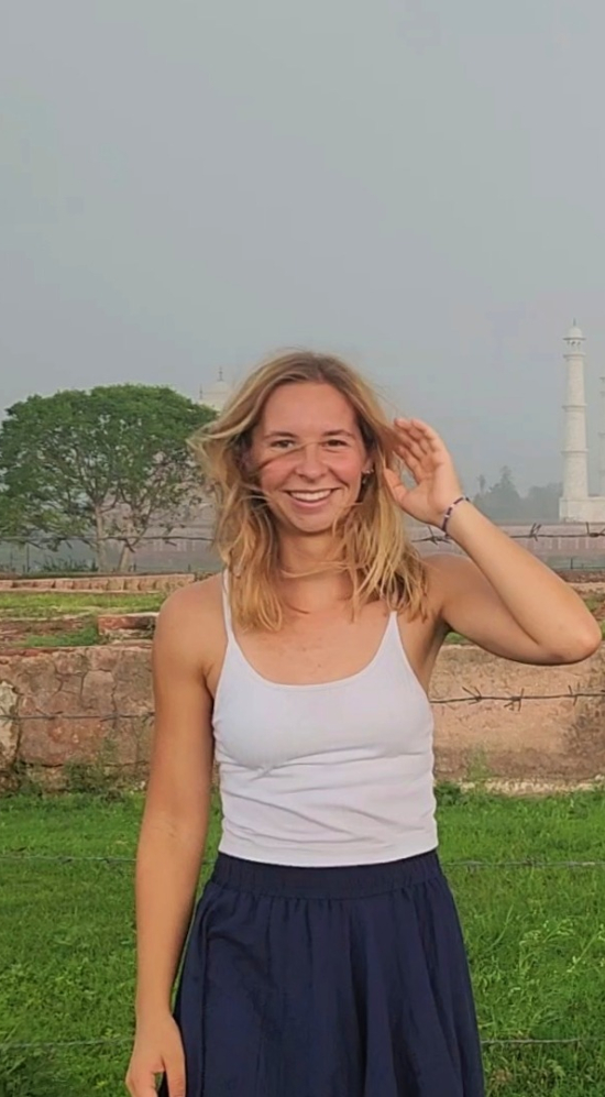 Sophia Woodbury mid shot with the Taj Mahal in India in the background