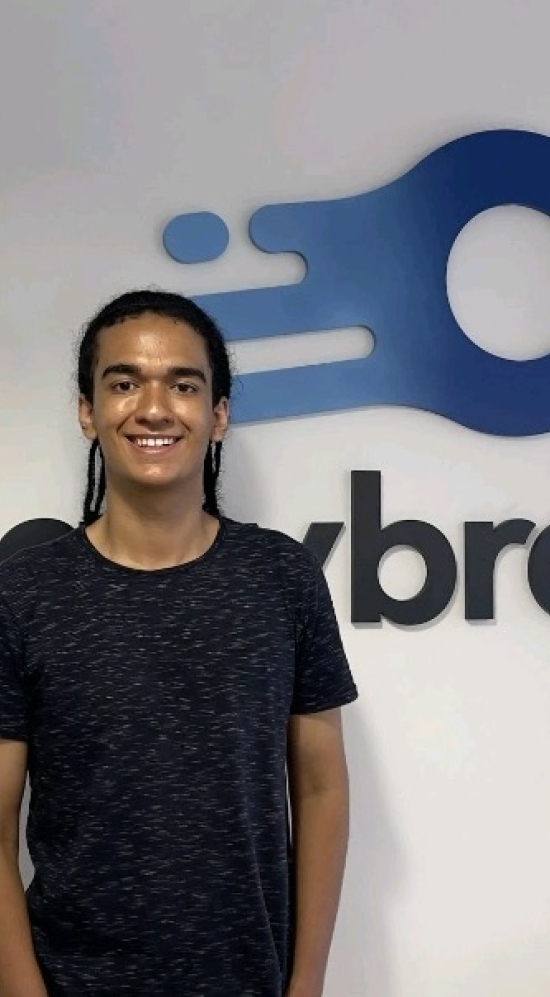 Gabriel Hemetrio standing in front of a logo by Anybrain