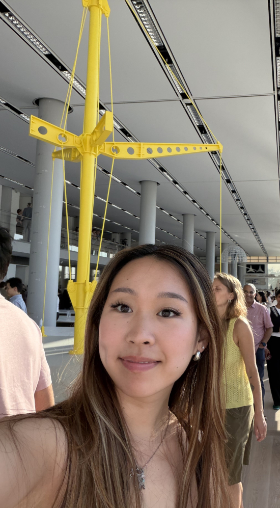 Selfie of Juliet Chui and another MIT student in a midst of a crowd