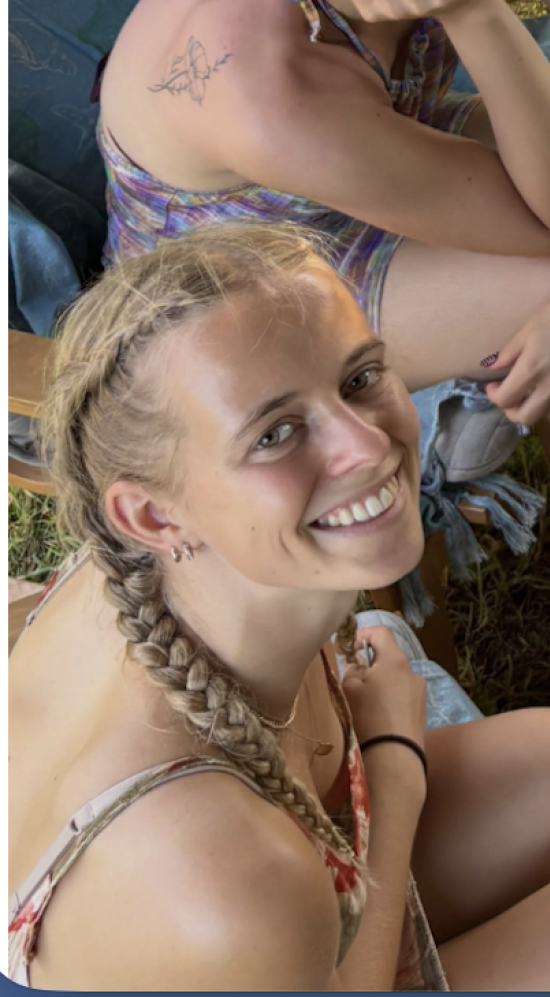 Lydia Birknes in braids looking up to the camera smiling