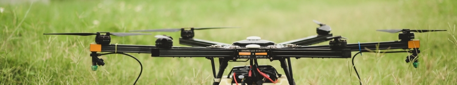 drone spraying over farming field