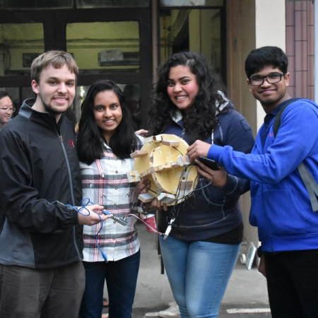 Mark Vrablic ’19 (left) and Agni Kumar ’20 (second from left) work with students from IIT Delhi to create a functional prototype of a balance board that can provide feedback about balance issues