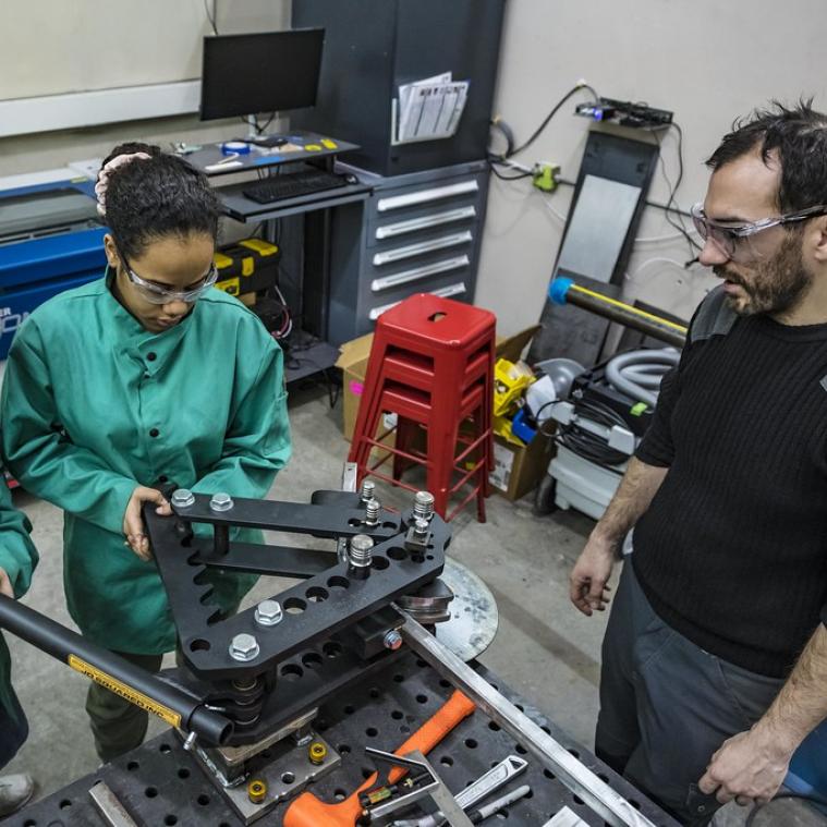 Students and faculty working in makerspace on MIT campus