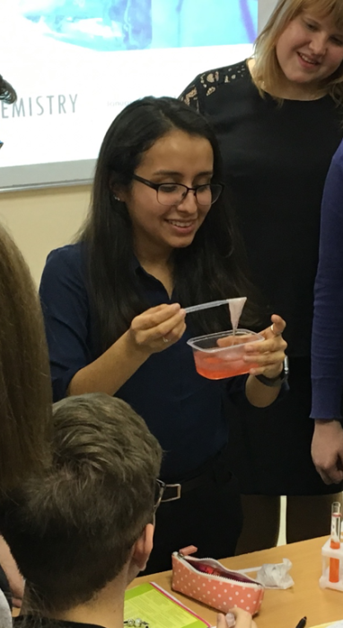 KAREN DEMONSTRATING A CHEMICAL REACTION IN HER KITCHEN CHEMISTRY CLASS WITH RUSSIAN STUDENTS.