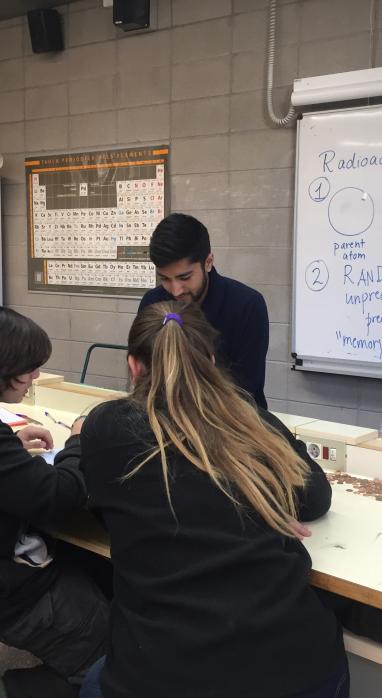 Shaun Datta in a classroom teaching students in a very engaging hands-on manner