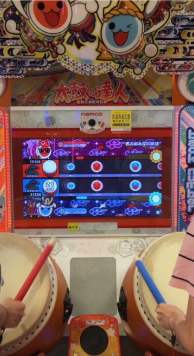Alex and a friend playing a game at an arcade near Shibuya