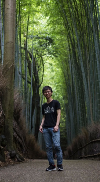 Kenneth Koh standing on a path in a forest