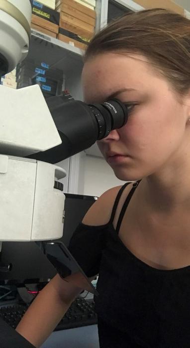 Kyla Truman busy as work with a microscope