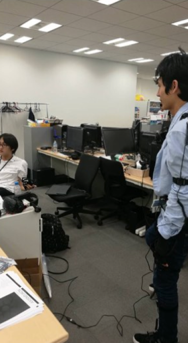 Larry wearing a motion capture suit at the Gree office in Tokyo