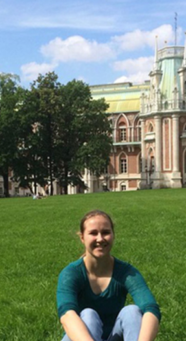 Rachel Price sitting on a grassy lawn in Moscow in 2017.