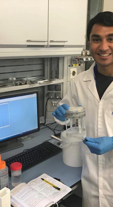 Rahul Ramakrishnan happily working in a lab.